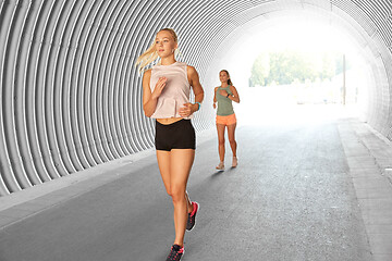 Image showing young women or female friends running outdoors