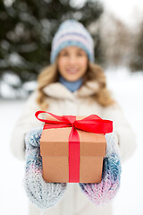 Image showing close up of woman with christmas gift in winter