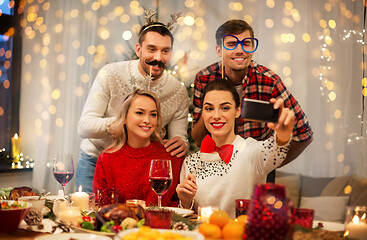 Image showing friends taking selfie at christmas dinner