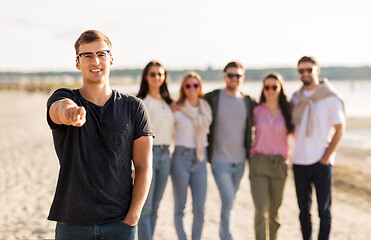 Image showing happy man with friends on beach in summer