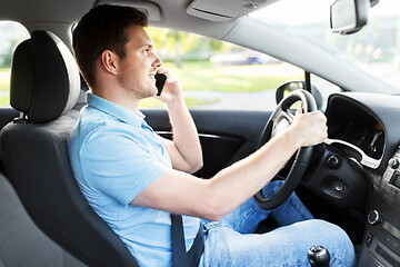 Image showing man driving car and calling on smartphone