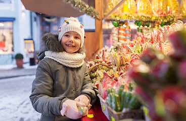 Image showing little girl choosing sweets at christmas market