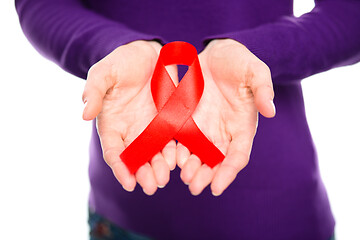 Image showing Woman is holding the red awareness ribbon