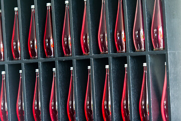 Image showing bottles of red juice in modern restaurant