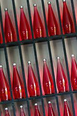 Image showing bottles of red juice in modern restaurant