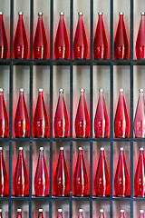 Image showing bottles of red juice in modern restaurant