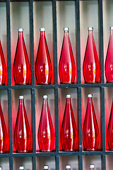 Image showing bottles of red juice in modern restaurant