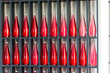 Image showing bottles of red juice in modern restaurant