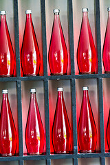 Image showing bottles of red juice in modern restaurant