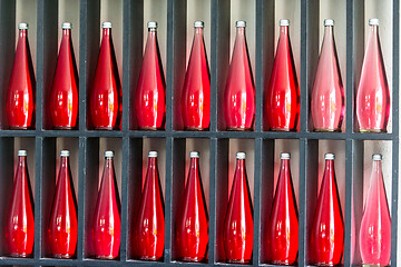 Image showing bottles of red juice in modern restaurant