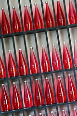 Image showing bottles of red juice in modern restaurant