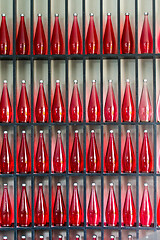 Image showing bottles of red juice in modern restaurant