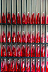 Image showing bottles of red juice in modern restaurant