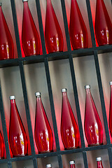 Image showing bottles of red juice in modern restaurant