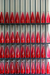 Image showing bottles of red juice in modern restaurant