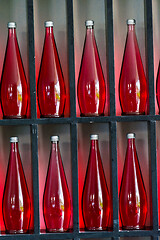 Image showing bottles of red juice in modern restaurant