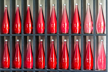 Image showing bottles of red juice in modern restaurant