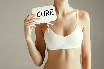 Image showing Woman health. Female model holding card near breast