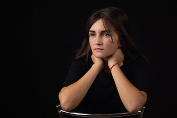 Image showing Portrait of a young girl with her elbows on the back of a chair