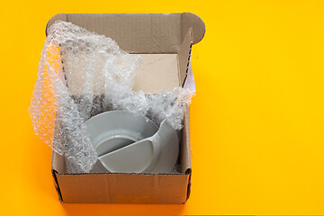 Image showing A parcel from an online store packed in a box, the dishes were broken when opened