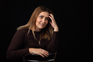 Image showing Portrait of a forty-year-old beautiful European woman on a black background