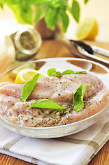 Image showing Raw chicken breasts marinating