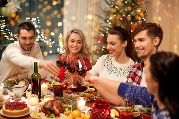 Image showing friends celebrating christmas and drinking wine