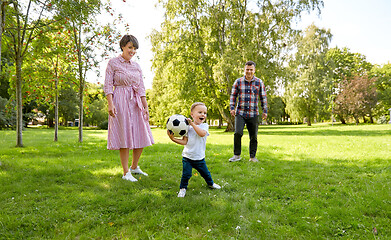 Image showing happy family playing soccer at summer park