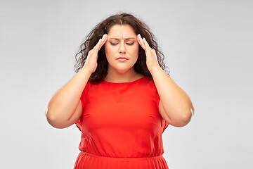 Image showing woman in red dress suffering from headache