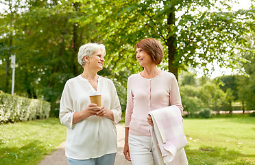 Image showing senior women or friends drinking coffee at park