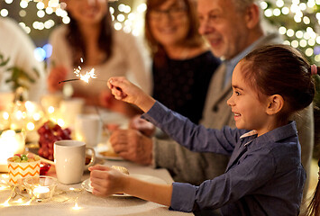 Image showing happy girl with sparkler at family tea party