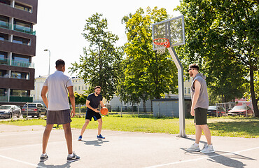 Image showing group of male friends playing street basketball