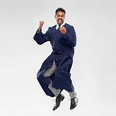 Image showing happy male indian graduate student jumping