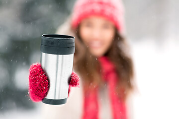 Image showing hand holding tumbler or thermo cup in winter