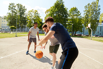 Image showing group of male friends playing street basketball