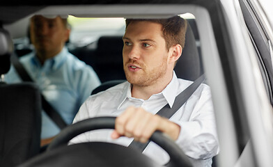 Image showing male driver driving car with passenger