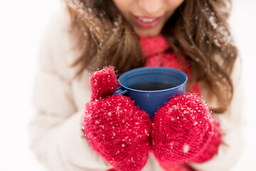 Image showing happy young woman with tea cup in winter park