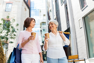 Image showing senior women with shopping bags and coffee in city