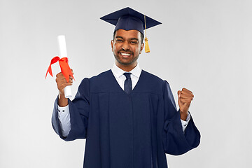 Image showing happy graduate student in mortarboard with diploma