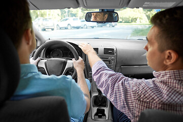 Image showing car driving school instructor teaching male driver