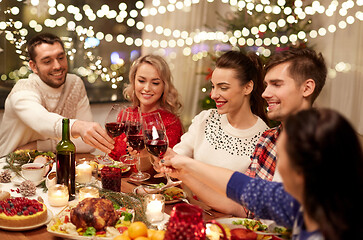 Image showing friends celebrating christmas and drinking wine