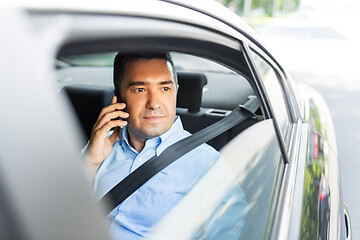 Image showing male passenger calling on smartphone in taxi car