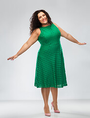 Image showing happy woman in green dress over posing