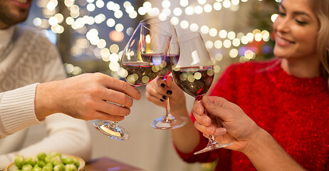 Image showing close up of friends with wine celebrate christmas