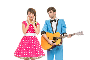 Image showing doll looking boy and girl with guitar