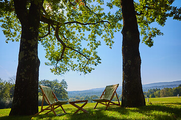 Image showing Relax with wooden chair and table. Enjoy the view of garden forest