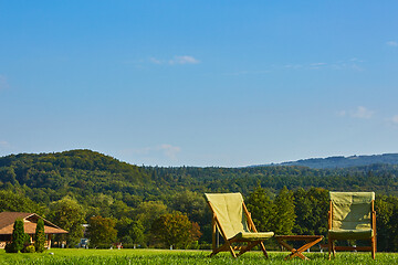 Image showing Relax with wooden chair and table. Enjoy the view of garden forest