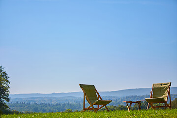 Image showing Relax with wooden chair and table. Enjoy the view of garden forest