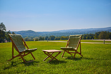 Image showing Relax with wooden chair and table. Enjoy the view of garden forest