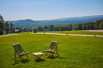 Image showing Relax with wooden chair and table. Enjoy the view of garden forest